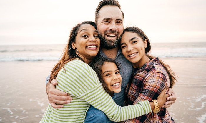 Happy family hugging and smiling